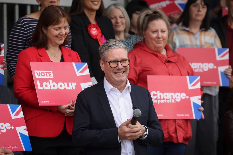 The leader of The Labour Party, Sir Keir Starmer, pictured during his visit to Hucknall Town Football Club. East Midlands Mayor Claire Ward is stood behind him