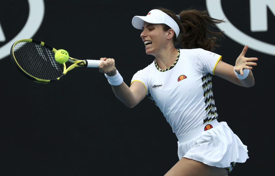 Johanna Konta of Britain makes a forehand return to Tunisia's Ons Jabeur during their first round singles match at the Australian Open tennis championship in Melbourne, Australia, Tuesday, Jan. 21, 2020. (AP Photo/Dita Alangkara)