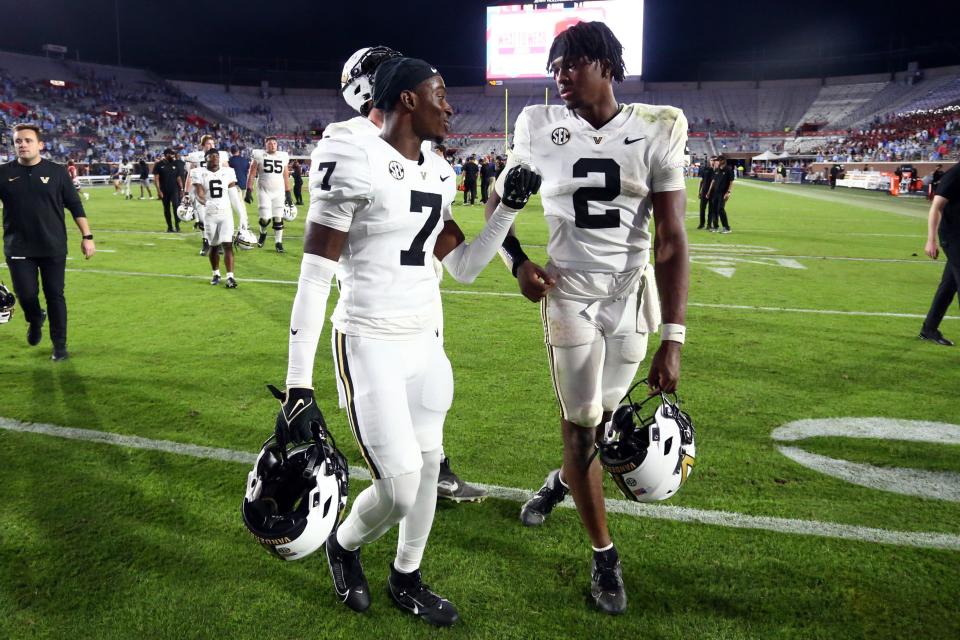 Oct 28, 2023; Oxford, Mississippi, USA; Vanderbilt Commodores defensive back Marlen Sewell (7) and quarterback Walter Taylor (2) talk as they walk off the field after the game against the Mississippi Rebels at Vaught-Hemingway Stadium. Mandatory Credit: Petre Thomas-USA TODAY Sports