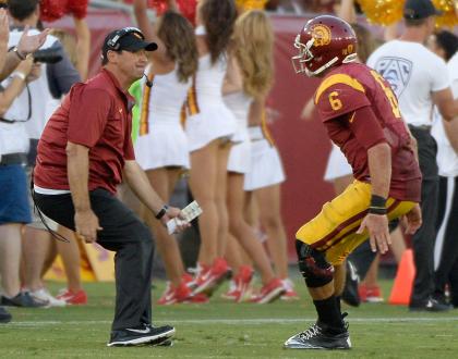 Steve Sarkisian celebrates a touchdown with Cody Kessler late in USC's win over Fresno State. (Getty)