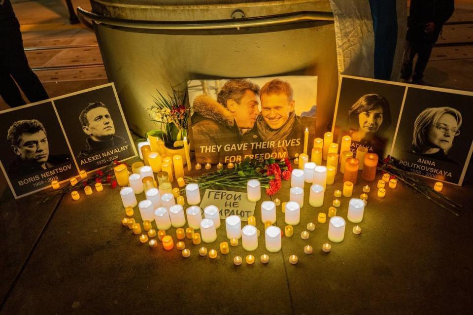 Candles illuminate photographs of Russian opposition leaders, including Alexei Navalny, who died in an Arctic penal colony earlier this month, and Boris Nemtsov, who was murdered on a Moscow bridge in 2015, during a vigil near the Tower Bridge in Sacramento on Tuesday.