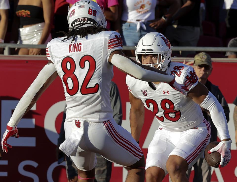 Utah Utes safety Sione Vaki (28) and tight end Landen King (82) celebrate Vaki’s touchdown against USC on Saturday, Oct. 21, 2023.