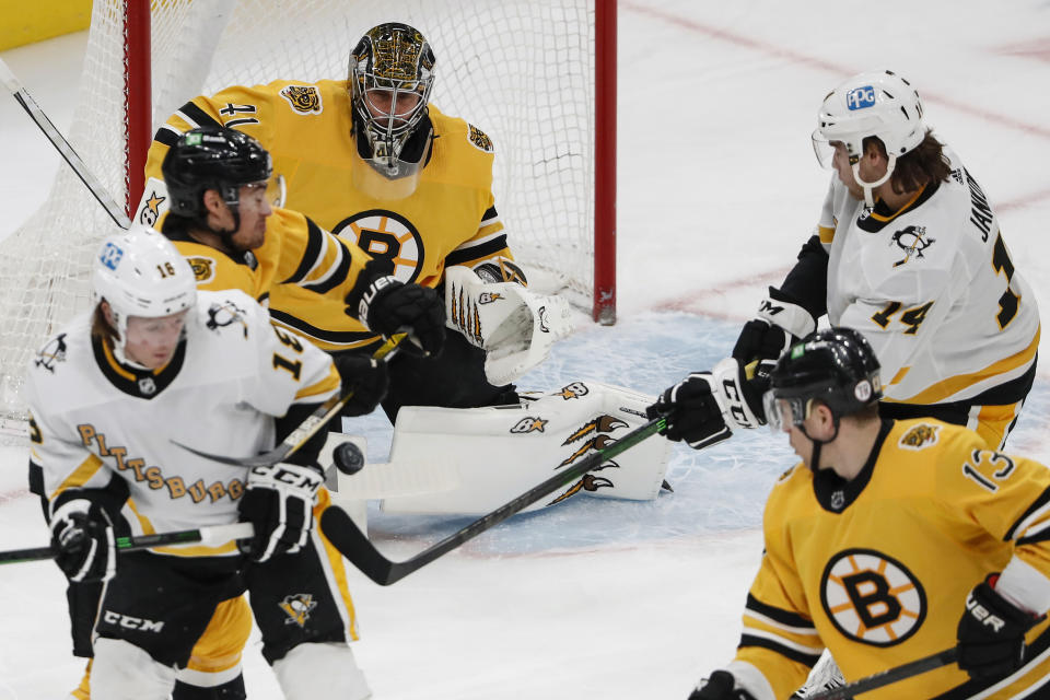 Pittsburgh Penguins' Mark Jankowski (14) deflects a puck that scored on Boston Bruins goaltender Jaroslav Halak during the first period of an NHL hockey game Saturday, April 3, 2021, in Boston. (AP Photo/Winslow Townson)