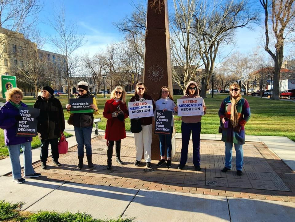 Protesters stand outside the Mary Lou Robinson United States Courthouse in Amarillo, Texas, ahead of a public hearing in a lawsuit against the abortion medication mifepristone on March 15.