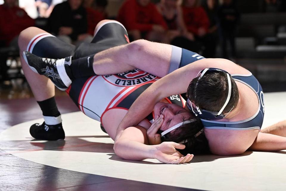 Penns Valley’s Landon Hess looks for nearfall points on Clearfield’s Nick Bailor in their 285-pound bout of the Rams’ 37-24 loss on Thursday. Hess pinned Bailor in 1:44.