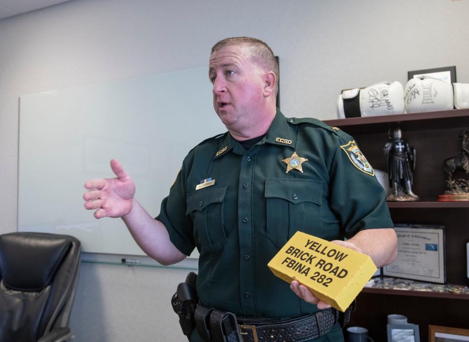 Cmdr. Andrew Hobbs talks about his Yellow Brick Road brick that is displayed in his office at the Escambia County Sheriff's Office in Pensacola on Thursday, June 30, 2022.  Hobbs earned the brick while recently completing the 10-week FBI National Academy program in Quantico, Virginia.