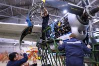 A Polar Airlines' Antonov An-24 passenger aircraft is serviced at an airport in Yakutsk