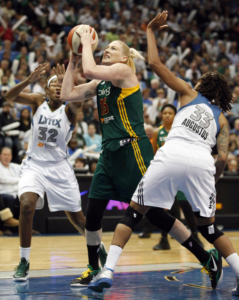 FILE - Seattle Storm forward Lauren Jackson (15) looks to shoot through the defense of Minnesota Lynx forward Rebekkah Brunson (32) and guard Seimone Augustus (33) in the second half of Game 3 of their WNBA basketball first-round playoff series, Tuesday, Oct. 2, 2012, in Minneapolis. Jackson is savoring every minute of her basketball comeback, in 2022, even though the battle-tested Australian hoops icon knows she can't do things that once captivated fans before retiring from the sport in 2016. (AP Photo/Stacy Bengs, File)