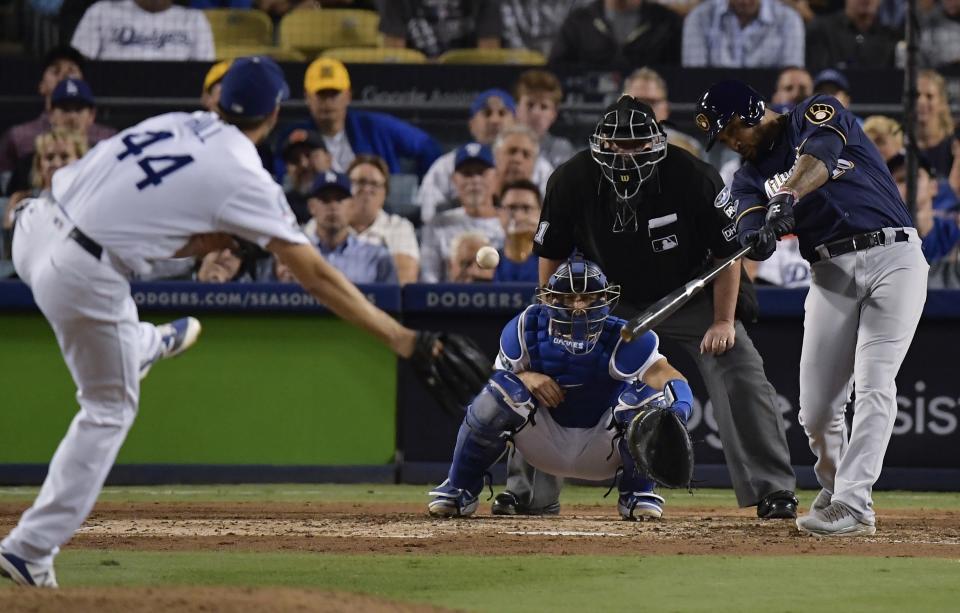 Milwaukee Brewers' Domingo Santana hits an RBI double during the sixth inning of Game 4 of the National League Championship Series baseball game against the Los Angeles Dodgers Tuesday, Oct. 16, 2018, in Los Angeles. (AP Photo/Mark J. Terrill)