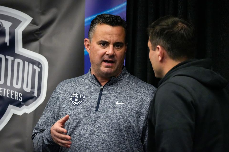 Xavier Musketeers head coach Sean Miller, left, speaks with Cincinnati Bearcats head coach Wes Miller at the Crosstown Shootout Party in 2023.