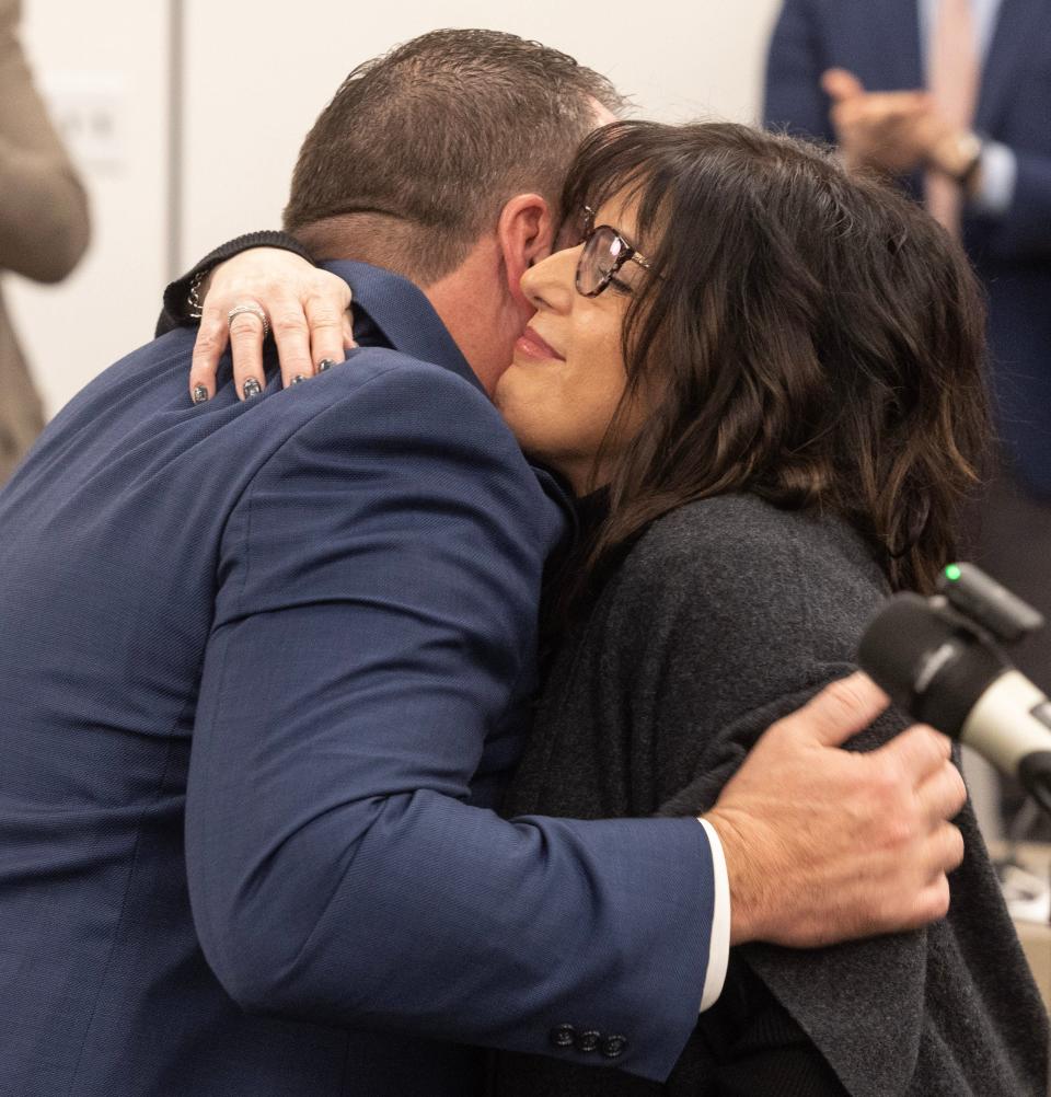 William Sherer II gets a hug from his wife, Carrie, after he was sworn in Thursday as Canton's new mayor.