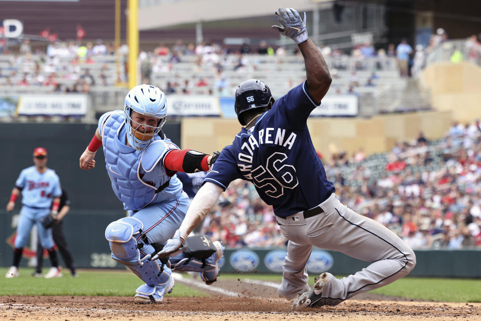 Tampa Bay Rays' Randy Arozarena scores against Minnesota Twins catcher Ryan Jeffers (27) during the fourth inning of a baseball game, Sunday, June 12, 2022, in Minneapolis. (AP Photo/Stacy Bengs)