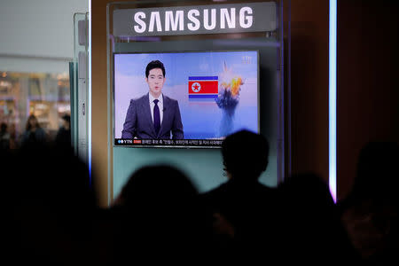 People watch a TV broadcasting a news report on North Korea's failed missile launch from its east coast, at a railway station in Seoul, South Korea, April 16, 2017. REUTERS/Kim Hong-Ji