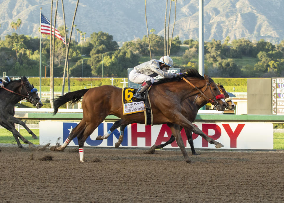 In a photo provided by Benoit Photo, Calvin Nguyen's Idol and jockey Joel Rosario, outside, overpower Express Train, with Juan Hernandez, inside, to win the Grade I, $400,000 Santa Anita Handicap horse race Saturday, March 6, 2021, at Santa Anita in Arcadia, Calif. (Benoit Photo via AP)