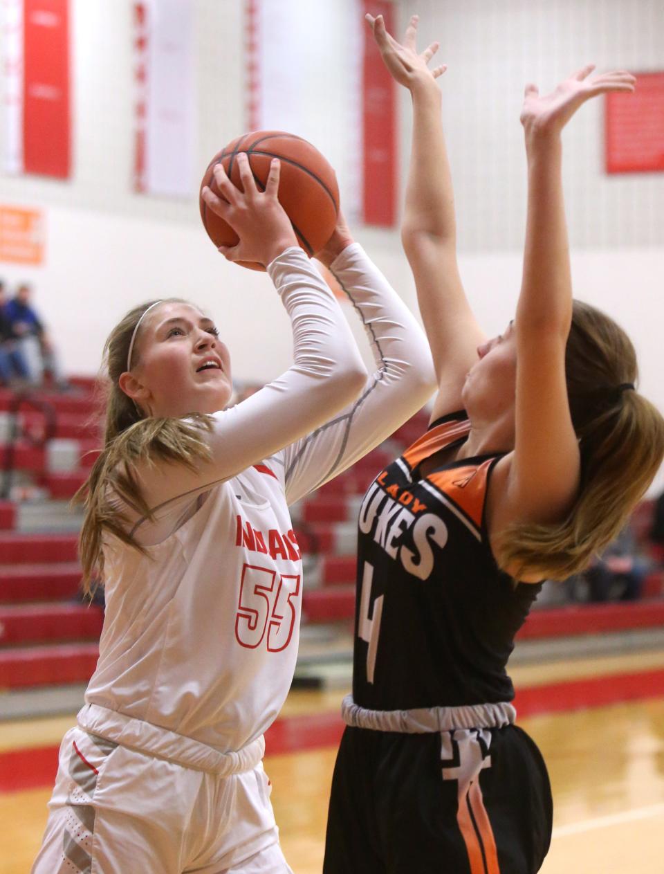 Lily Bottomley (55) of Northwest takes a shot while being defended by Lexi Miller (4) of Marlington during their game at Northwest on Wednesday, Dec. 30, 2020. 