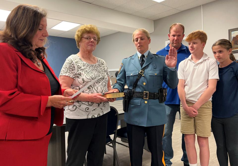 Councilwoman Donna Puglisi administers the oath to Carver, accompanied by her family.