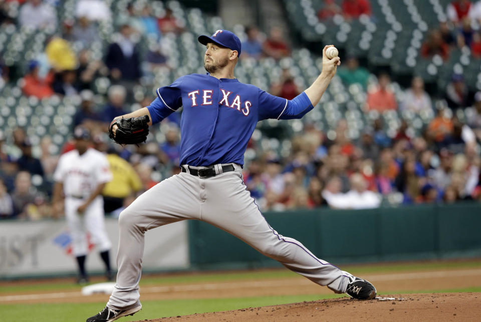 Texas Rangers' Matt Harrison delivers a pitch against the Houston Astros in the first inning of a baseball game Tuesday, May 13, 2014, in Houston. (AP Photo)