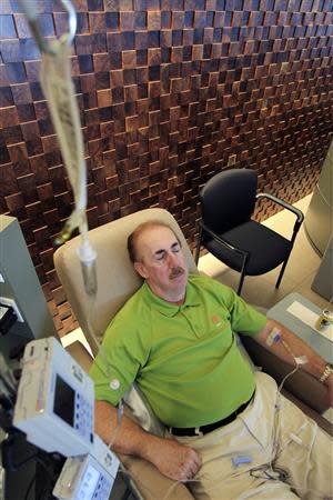 Cancer patient Stew Scannell receives an intravenous dose of lambrolizumab during a promising cancer treatment clinical trial at UCLA Medical Center in Los Angeles, California in this August 19, 2013 file picture. REUTERS/David McNew