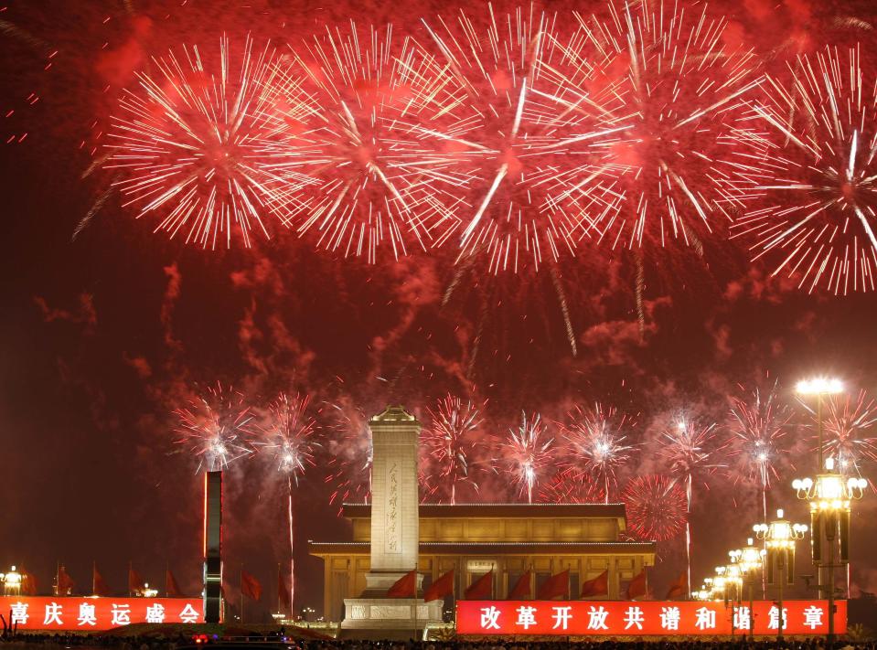 FILE - Fireworks explode over Beijing's Tiananmen Square to help mark the closing of the Beijing 2008 Olympics in Beijing on Aug. 24, 2008. The 2022 Beijing Winter Olympics open in just over a week. When Beijing held the Summer Olympics in 2008 the International Olympic Committee predicted they could improve human rights, and Chinese politicians hinted at the same. There are no soaring promises this time. (AP Photo/Vincent Yu, File)