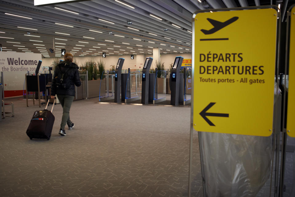 A lonely woman walks towards the boarding room at the Toulouse-Blagnac airport in Toulouse, France, on April 1, 2020. As the Covid-19 massive outbreak concerns nearly all countries and due to travel restrictions all over the world, airports, air carriers suffer. Some compagnies ground all their planes, some continue with a light schedule. In the Toulouse-Blagnac airport, only a terminal stays open as the number of flights have plummeted to only 7 or 8 flights per day (more than 100 on a normal day). Dozens and dozens of flights are cancelled. The Paris Orly airport is closed from now until further notice as the Beauvais airport. All shops or coffes in the airport are closed.  (Photo by Alain Pitton/NurPhoto via Getty Images)