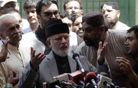 Muhammad Tahirul Qadri, Sufi cleric and leader of political party Pakistan Awami Tehreek (PAT) speaks to supporters before they begin their march to the capital from Lahore August 14, 2014. REUTERS/Mohsin Raza