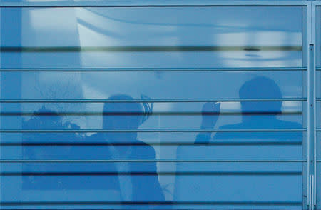 German Interior Minister Horst Seehofer and Chancellor Angela Merkel are pictured through a window as they talk during a meeting to decide about the future of Hans-Georg Maassen, head of the BfV domestic intelligence agency at the chancellery in Berlin, Germany, September 18, 2018. REUTERS/Fabrizio Bensch