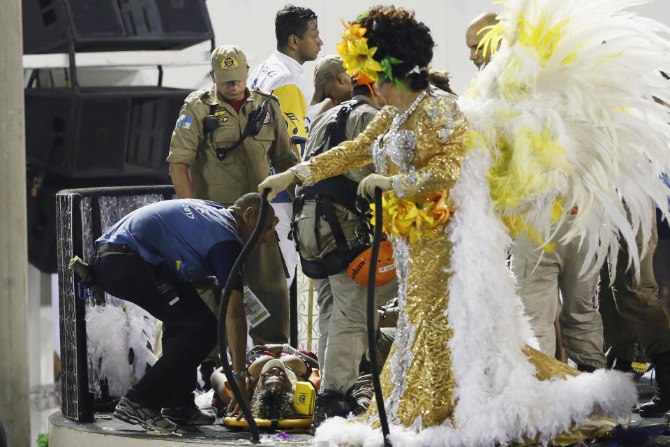 An injured person lies on a stretcher on the top of a float as she is being rescued during the performing of the Unidos da Tijuca samba school for the Carnival celebrations at the Sambadrome in Rio de Janeiro, Brazil, Tuesday, Feb. 28, 2017. Part of a float has collapsed during Rio de Janeiro's world famous Carnival parade, injuring several people, according to doctors at the scene. (AP Photo/Leo Correa)