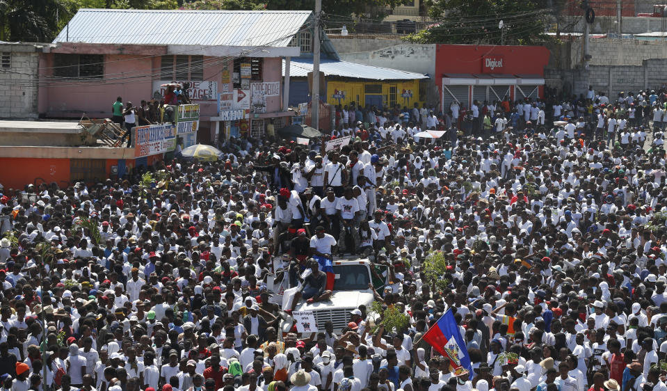 Protesters led by the art community demand the resignation of Haitian President Jovenel Moise as they march through Port-au-Prince, Haiti, Sunday, Oct. 13, 2019. Protests have paralyzed the country for nearly a month, shuttering businesses and schools. (AP Photo/Rebecca Blackwell)