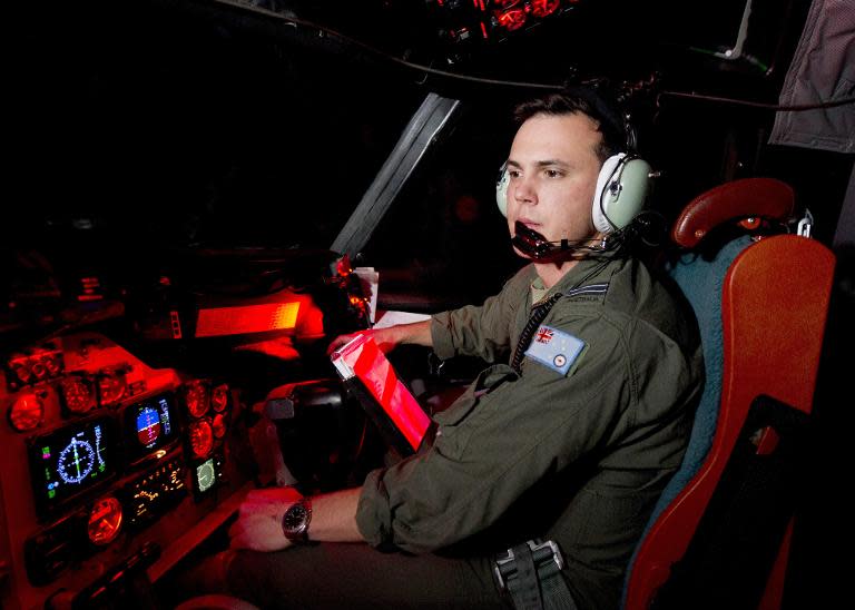 This handout photo released on March 24, 2014 shows an Australian polot at the controls of an AP-3C Orion during the search for Malaysia Airlines flight MH370 in the southern Indian Ocean