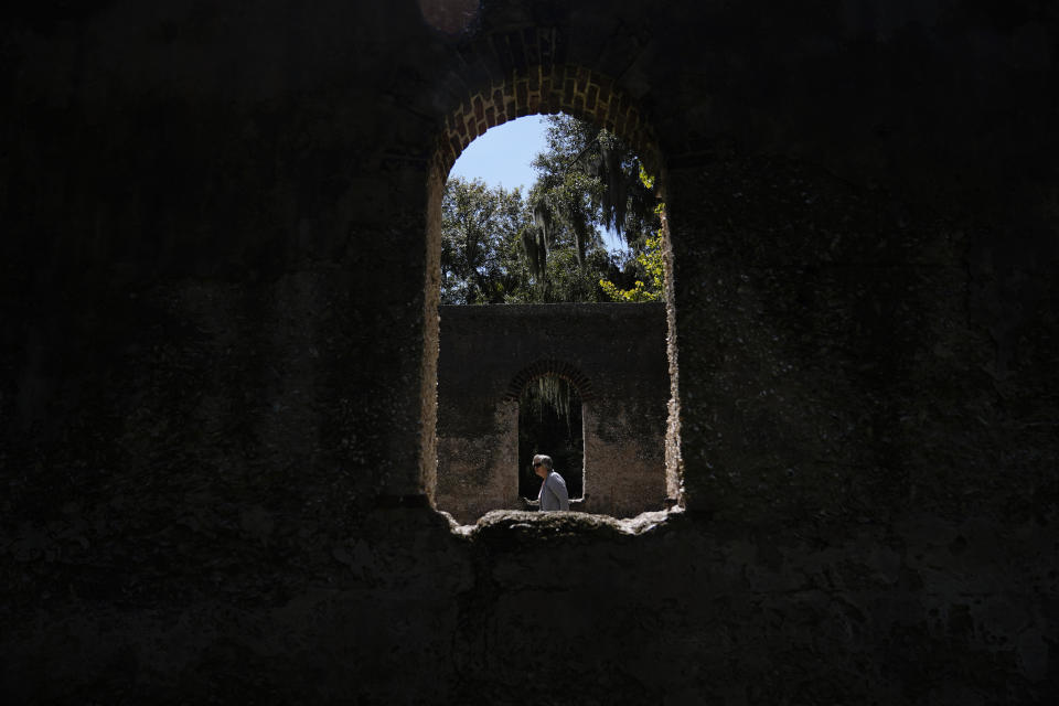 A person walks through the Saint Helena Parish Chapel of Ease Ruins on Tuesday, Sept, 19, 2023, in St. Helena Island, S.C. Historic Black communities have dwindled from their once-thriving existence in the United States and efforts to preserve what's left encounter complicated challenges. (AP Photo/Brynn Anderson)
