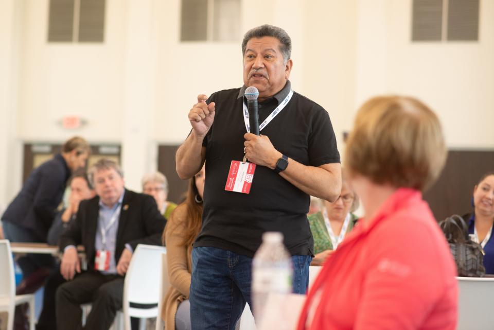 Topeka Mayor Mike Padilla poses a question about working with the state legislature to the mayors of northwest Arkansas cities during a forum on the second day of the intercity trip.