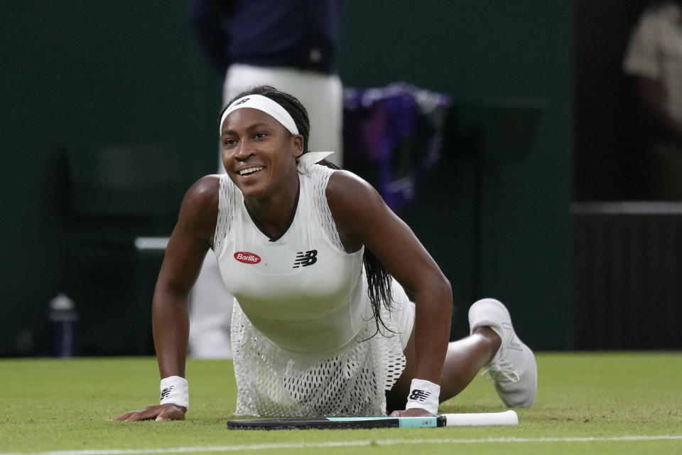 Coco Gauff of the US falls as she tries to make a return to Romania's Mihaela Buzarnescu in a second round women's singles match on day four of the Wimbledon tennis championships in London, Thursday, June 30, 2022. (AP Photo/Kirsty Wigglesworth)