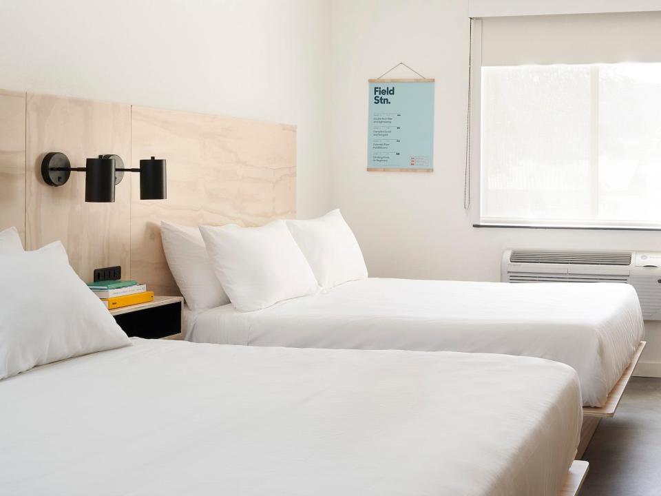 Inside a Field Station hotel room with two beds, furniture.