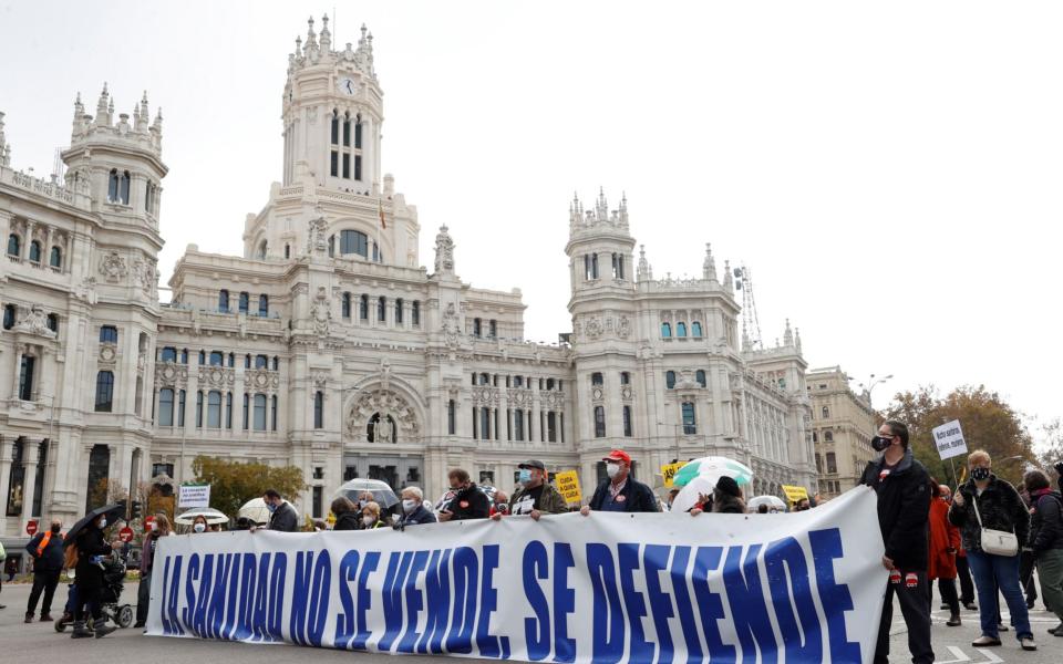 Health workers hold a banner that reads 'You don't sell health, you defend it' as they take part in a protest held in defense of the Public Health system in Madrid, - Chema Moya/EPA-EFE/Shutterstock 