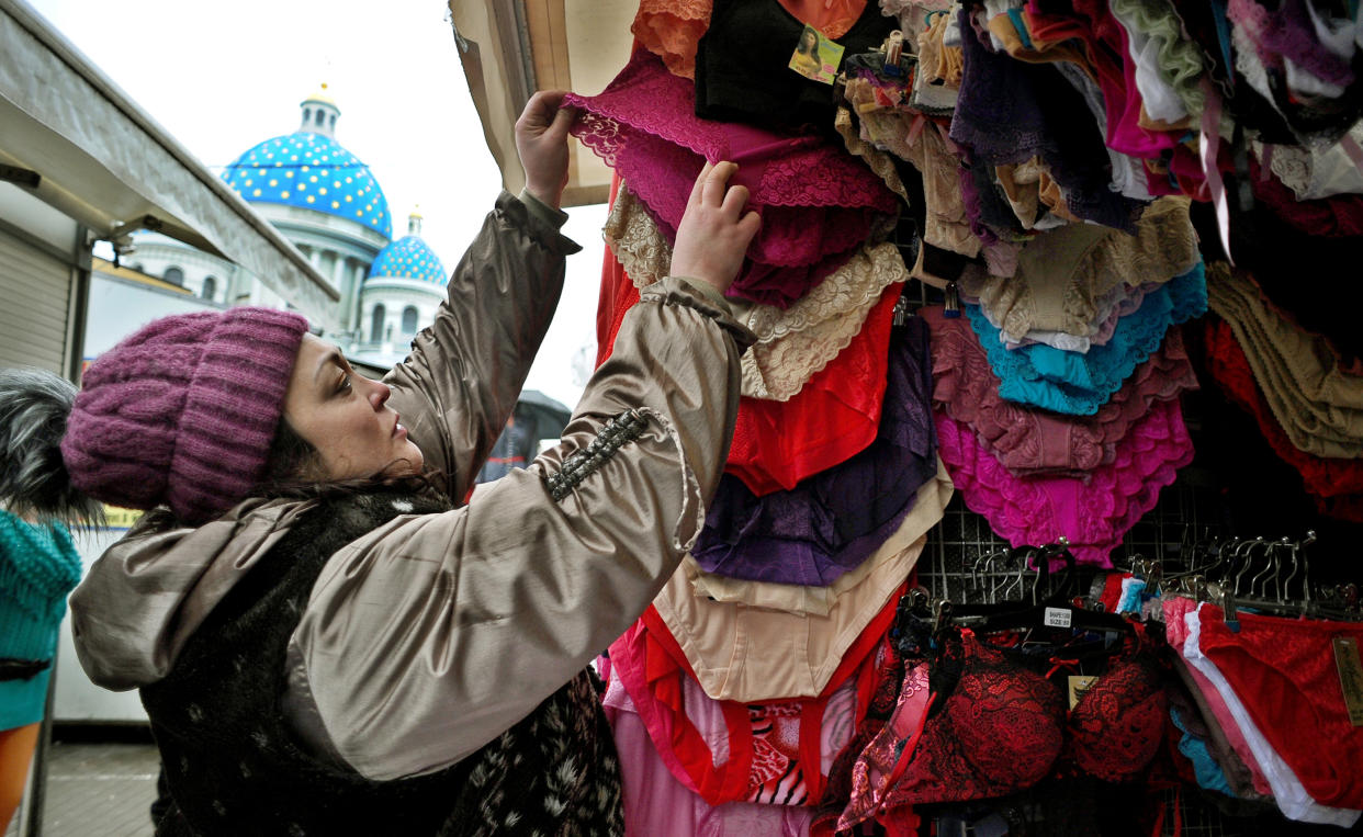 TO GO WITH AFP STORY BY ANNA MALPAS
A woman chooses lacy pants at an outdoor market in St. Petersburg, on February 19, 2014. Russia and two of its ex-Soviet neighbours are set to impose a ban on certain types of lacy pants, sparking public fury and even a street protest. AFP PHOTO / OLGA MALTSEVA        (Photo credit should read OLGA MALTSEVA/AFP via Getty Images)