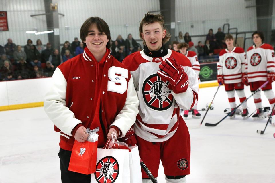 Spaulding High School junior Matt Gould, left, shares a funny moment with his good friend and hockey player Owen Nesbitt after Gould dropped a ceremonial puck before the start of Wednesday's Division II boys hockey game against Portsmouth/Newmarket at Rochester Ice Arena.