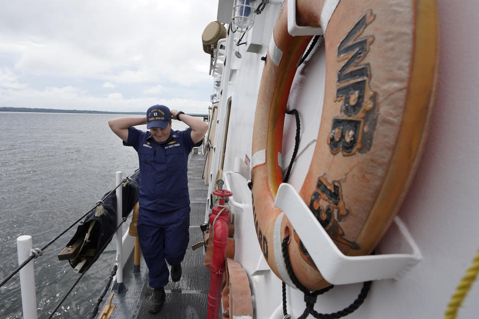 U.S. Coast Guard Lt. Kelli Normoyle, Commanding Officer of the Coast Guard Cutter Sanibel, adjusts her hat while walking on the deck of the vessel, Thursday, Sept. 16, 2021, at a shipyard in North Kingstown, R.I. Normoyle was one of two cadets who formally started the process to create the CGA Spectrum Diversity Council just a few months after the law known as "don't ask, don't tell" was repealed on Sept. 20, 2011. (AP Photo/Steven Senne)