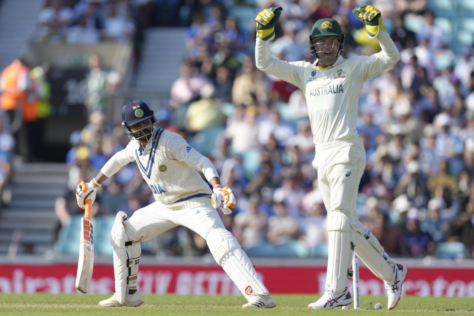 India's Ravindra Jadeja, left looks round as he is caught out by Australia's Steven Smith , as Australia's wicketkeeper Alex Careyon starts to celebrate on the second day of the ICC World Test Championship Final between India and Australia at The Oval cricket ground in London, Thursday, June 8, 2023. (AP Photo/Kirsty Wigglesworth)