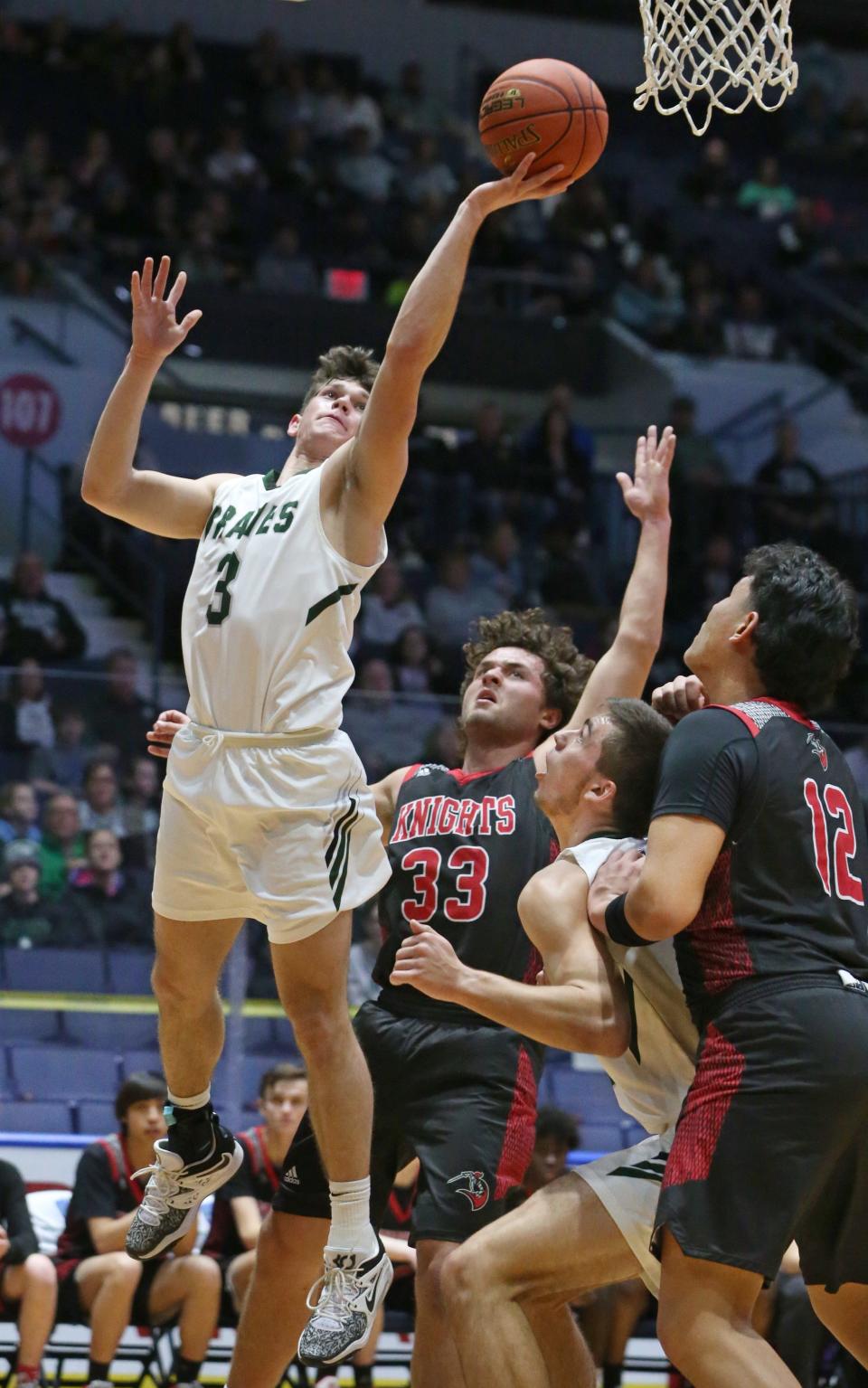 Avon's Michael Rowland drives in for two points over Northstar Christian's David Eschner during their Class C1 Championship final Sunday, March 5, 2023 a the Blue Cross Arena.