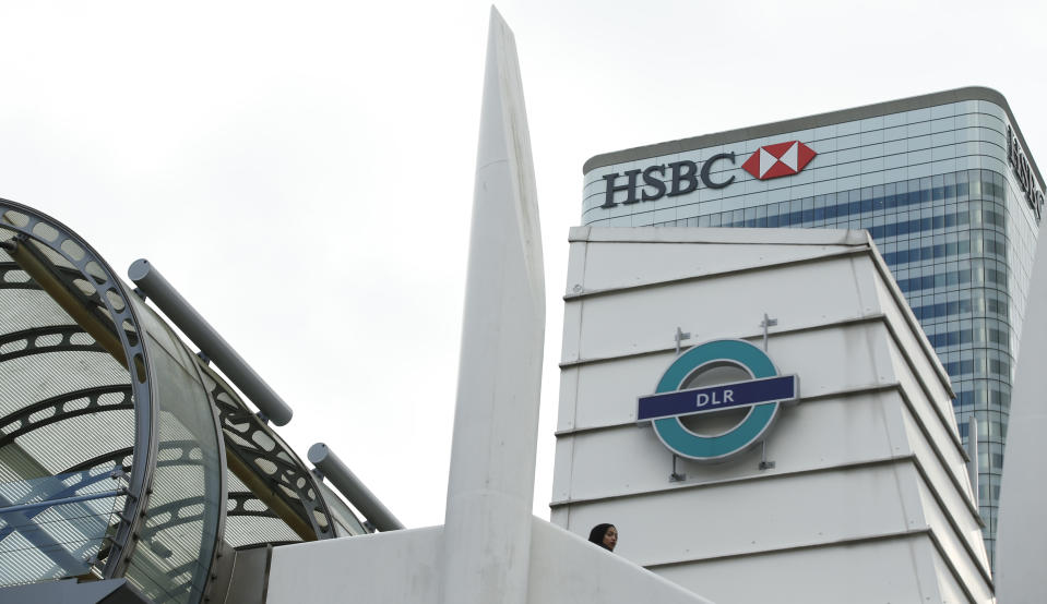 A general view of the headquarters of the banking giant HSBC, with the Poplar Dockland Light Railway station in front, at Canary Wharf in London Monday, Feb. 15, 2016. HSBC Holdings plc said late Sunday that it will keep its headquarters in London, ending a months long process in which one of the world’s largest financial companies considered moving to Hong Kong to get closer to its centre of gravity in fast-growing Asian economies. The bank launched the review last April in light of regulatory and tax changes implemented by the U.K. after the 2008 financial crisis.(AP Photo/Alastair Grant)