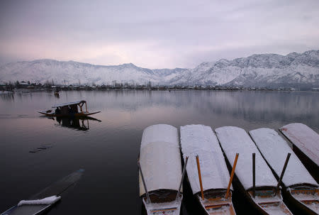 A man rows his boat in the waters of the Dal lake on a cold winter morning in Srinagar February 8, 2019. REUTERS/Danish Ismail/File Photo