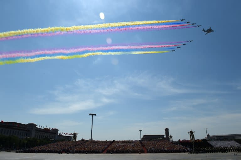 A Chinese People's Liberation Army Air Force KJ-2000 airborne early warning and control aircraft (C) flies in formation with Chengdu J-10 multirole fighter jets during a military parade at Tiananmen Square in Beijing, on September 3, 2015