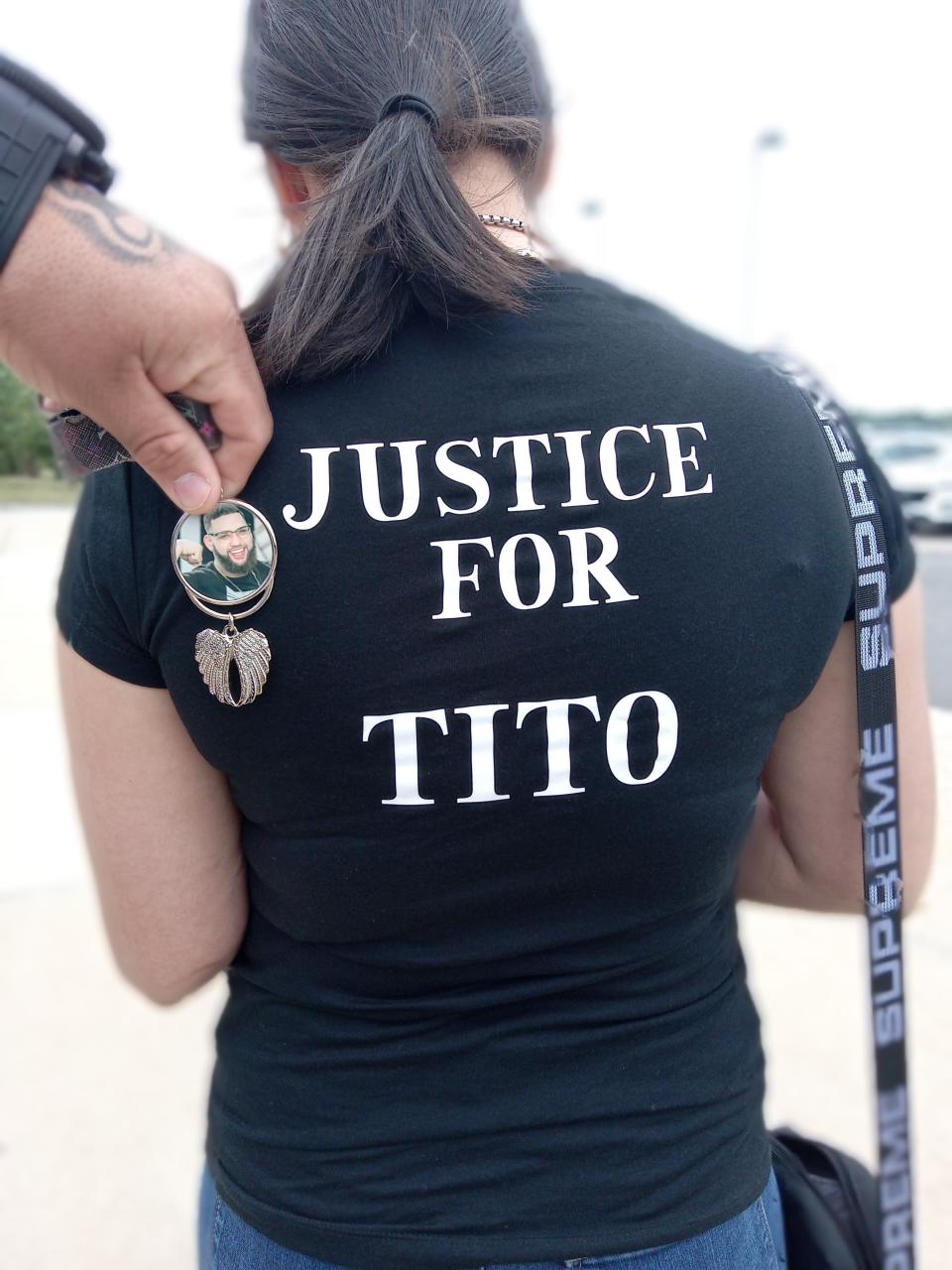 Chaisek Flores, a sister of shooting victim Robert Aponte-Flores, wears a T-shirt in honor of her brother, who went by the nickname "Tito." Family members also wore pendants with his picture to the Aug. 7 arraignment of the man accused of shooting him.