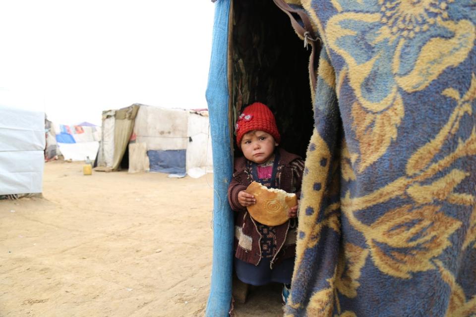 Zabi, three, peers out of the tent where she lives (Michal Przedlacki/Save the Children)