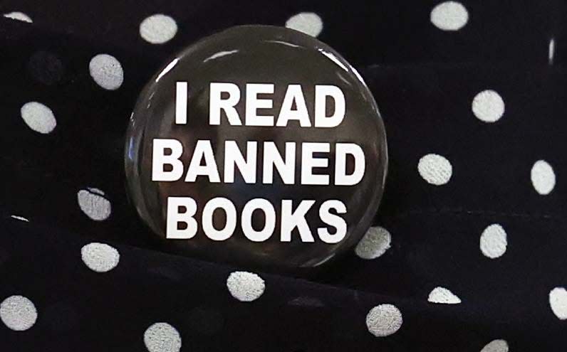 A button on display at an Oct. 4, 2023, forum on book banning held at a public library in Bridgewater, Massachusetts. At a recent Sarasota County Commission meeting, several speakers called on the county to end its links to two library associations. The speakers accused the organizations of promoting ideological and explicit reading materials in public libraries.