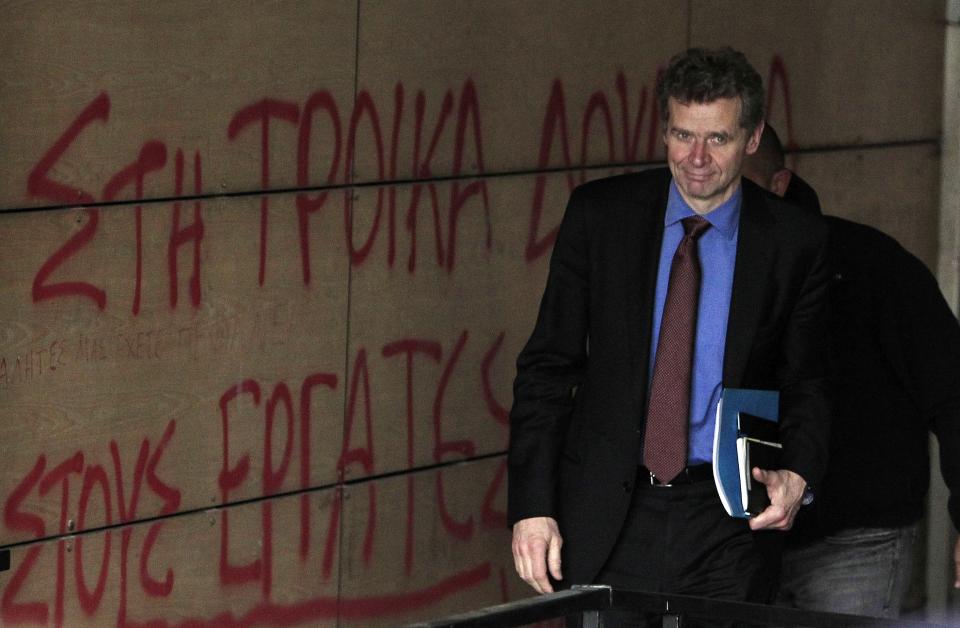 Poul Thomsen, the director of the IMF's mission to Greece enters the Finance Ministry during a rally in Athens, on Friday, Feb. 28, 2014. Hundreds of teachers, municipality workers, school guards and cleaning women who have been suspended on reduced pay pending transfer to other public sector jobs or dismissal, took part in the protest as the officials from the European Union, European Central Bank and International Monetary Fund, together known as the troika, were holding talks with the Minister of Administration Reform Kyriakos Mitsotakis and other government officials. The conservative-led government has committed to sack thousands of civil servants this year, as part of its austerity commitments to bailout creditors whose rescue loans have kept Greece afloat since 2010. (AP Photo/Thanassis Stavrakis)