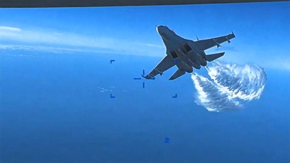 Footage from a U.S. Air Force MQ-9 drone shows a Russian SU-27 aircraft jettissoning fuel over The Black Sea on March 14, 2023.