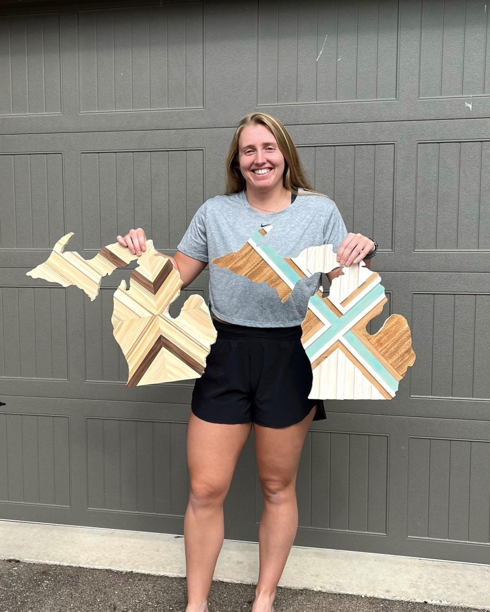 Morgan Patterson poses with two pieces she made for the upcoming East Lansing Art Festival. Patterson is one of the festival's Emerging Artists.