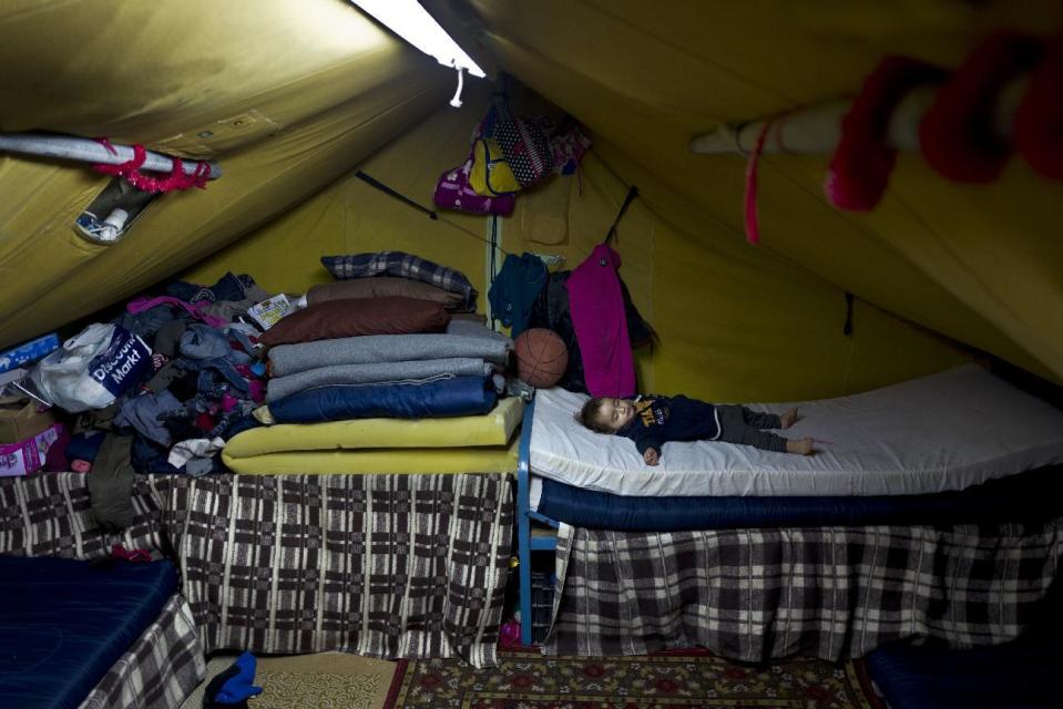 In this Thursday, Jan. 19, 2017 photo, Syrian refugee Elan Darwish, 14 months, sleeps inside his family's tent in Kalochori refugee camp on the outskirts of the northern Greek city of Thessaloniki. (AP Photo/Muhammed Muheisen)