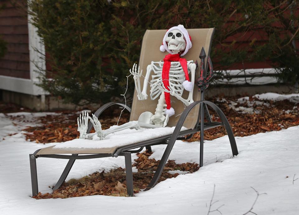 A skeleton wearing a scarf and hat is seen in a lawn chair Wednesday, Jan. 25, 2023, ahead of the third winter storm expected to hit the area in less than one week.
